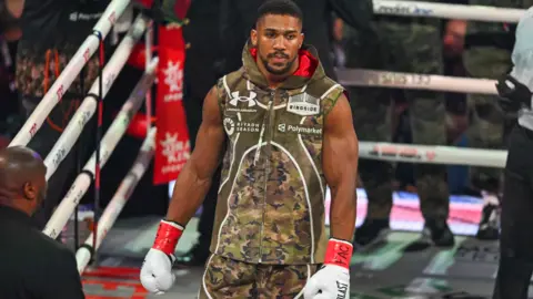 AFP via Getty Images Anthony Joshua arrives for his non-title heavyweight bout against US boxer and influencer Jake Paul at the Kaseya Center in Miam