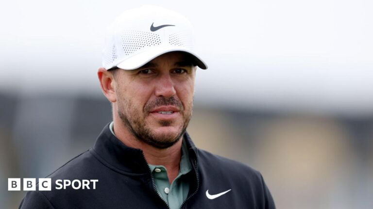 Brooks Koepka looks towards a green