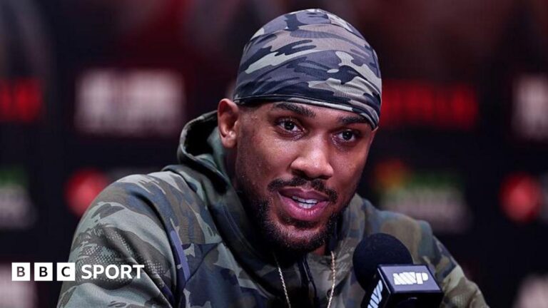 Anthony Joshua: Boxer flies back to UK after fatal crash in Nigeria Anthony Joshua speaking during a news conference before his fight against Jake Paul