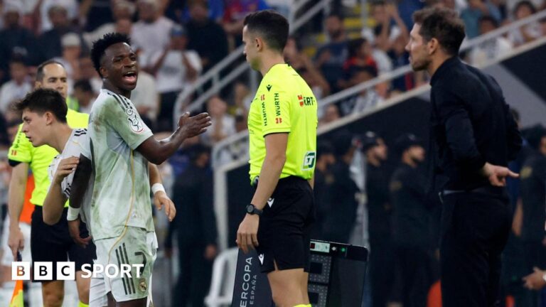 Real Madrid winger Vinicius Jr is substituted against Atletico Madrid, whose manager Diego Simeone watches from the touchline