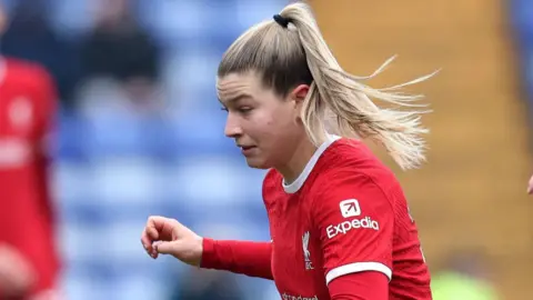 Reuters Liverpool midfielder Marie Hobinger pictured during a match. She is wearing the club's red kit. 