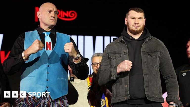Tyson Fury and Arslanbek Makhmudov pose with their fists up for pictures