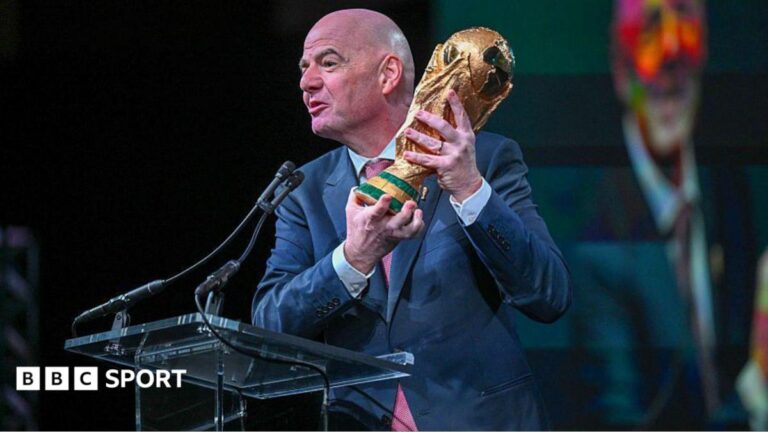 FIFA president Gianni Infantino holds the FIFA World Cup trophy